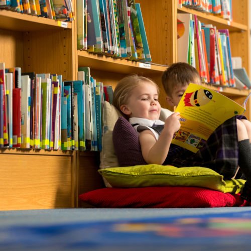 wycliffe nursery chikdren reading in the library